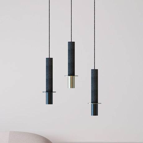 Rita Concrete Pendant lights in matt black with a disc detail and brass and black iron heads, shown in three lengths against a plain light background.