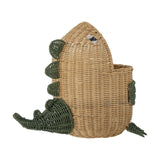 Eddi Dinosaur Rattan Basket in natural, shaped like a dinosaur with a raised head, woven eye, green spine ridges, short arms and a sweeping tail, on a white background.