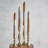 Pack of 4 dip-dyed fluted taper candles in brass turned candlesticks, with white, grey, and brown banded tones, shown on a plain light grey background.