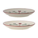 Yule Stoneware Christmas Plates Set of 2 in cream, round side plates with red painted rims and a pine sprig and heart motif, shown stacked on a white background.