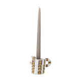 Caty Striped Stoneware candle holder shaped like a cat with a ribbed body, looped tail handle and gold-and-blue striped finish, holding a tall taupe taper candle on a white background.
