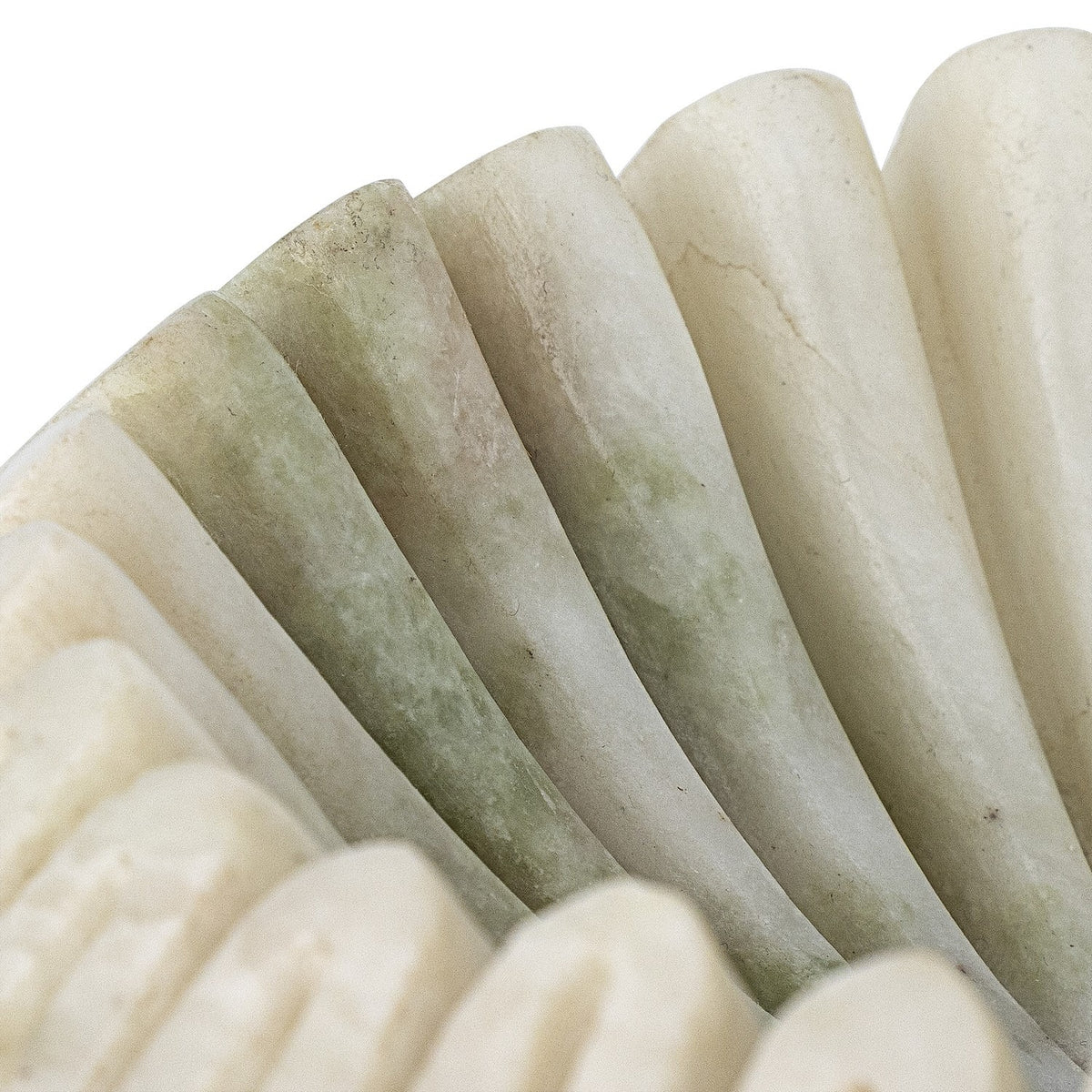 Close-up of the Harmonia Fluted Marble Bowl in white, showing polished marble ridges with natural green-grey veining and a wavy, pleated rim.