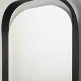 Close-up of the rounded top of the frame, the black metal enclosing the oval glass in a single formed line.