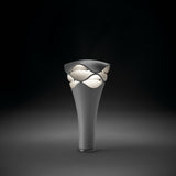Cornet B/52 cone LED bollard light in stone grey, with a tapered aluminium base and a wavy-edged cap revealing stacked white diffuser layers, shown against a dark background.