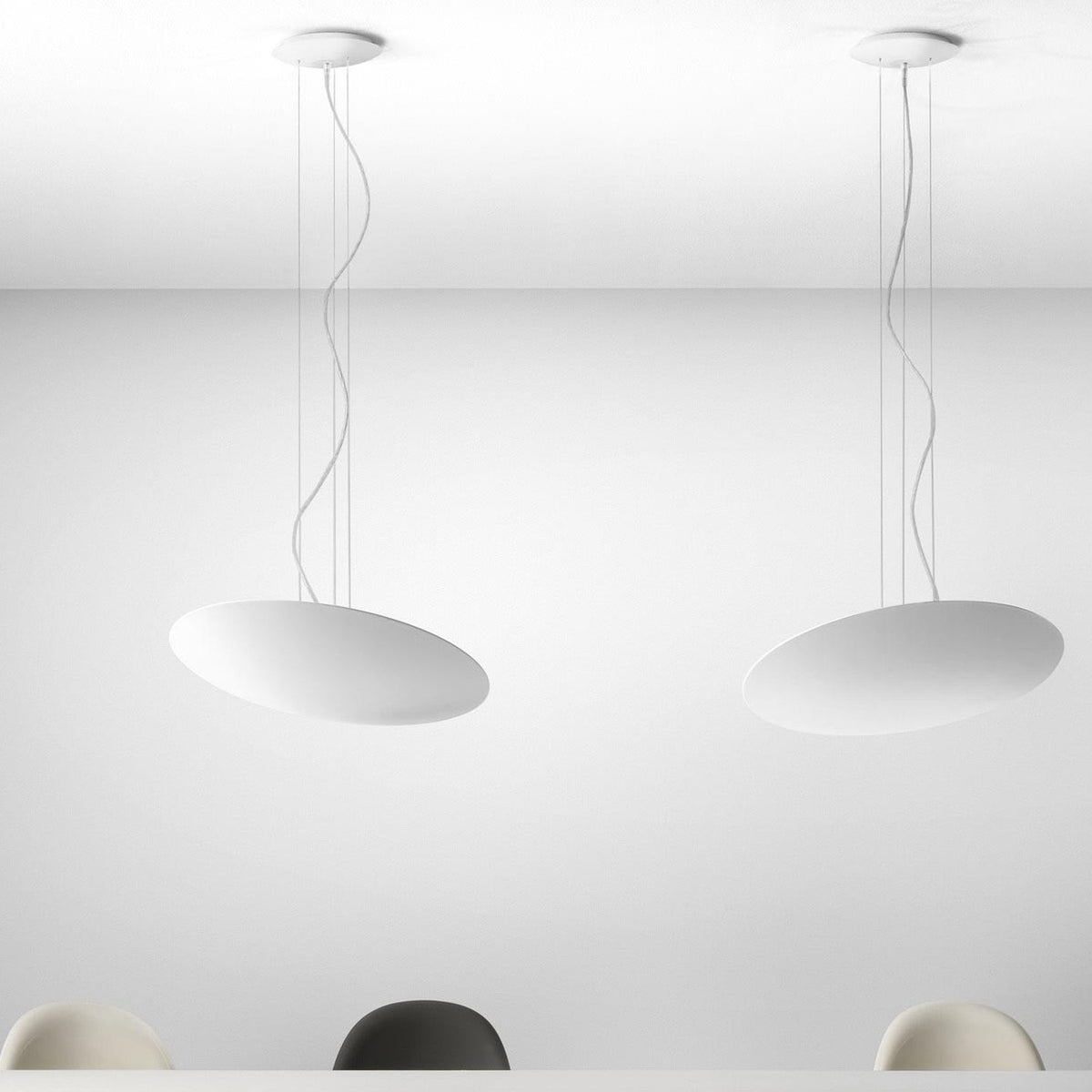 Gong Aluminium Disc LED Pendant Light 60cm in white, shown as two shallow oval discs suspended on fine wires from round ceiling canopies against a plain white interior.