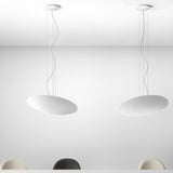 Gong Aluminium Disc LED Pendant Light 60cm in white, shown as two shallow oval discs suspended on fine wires from round ceiling canopies against a plain white interior.