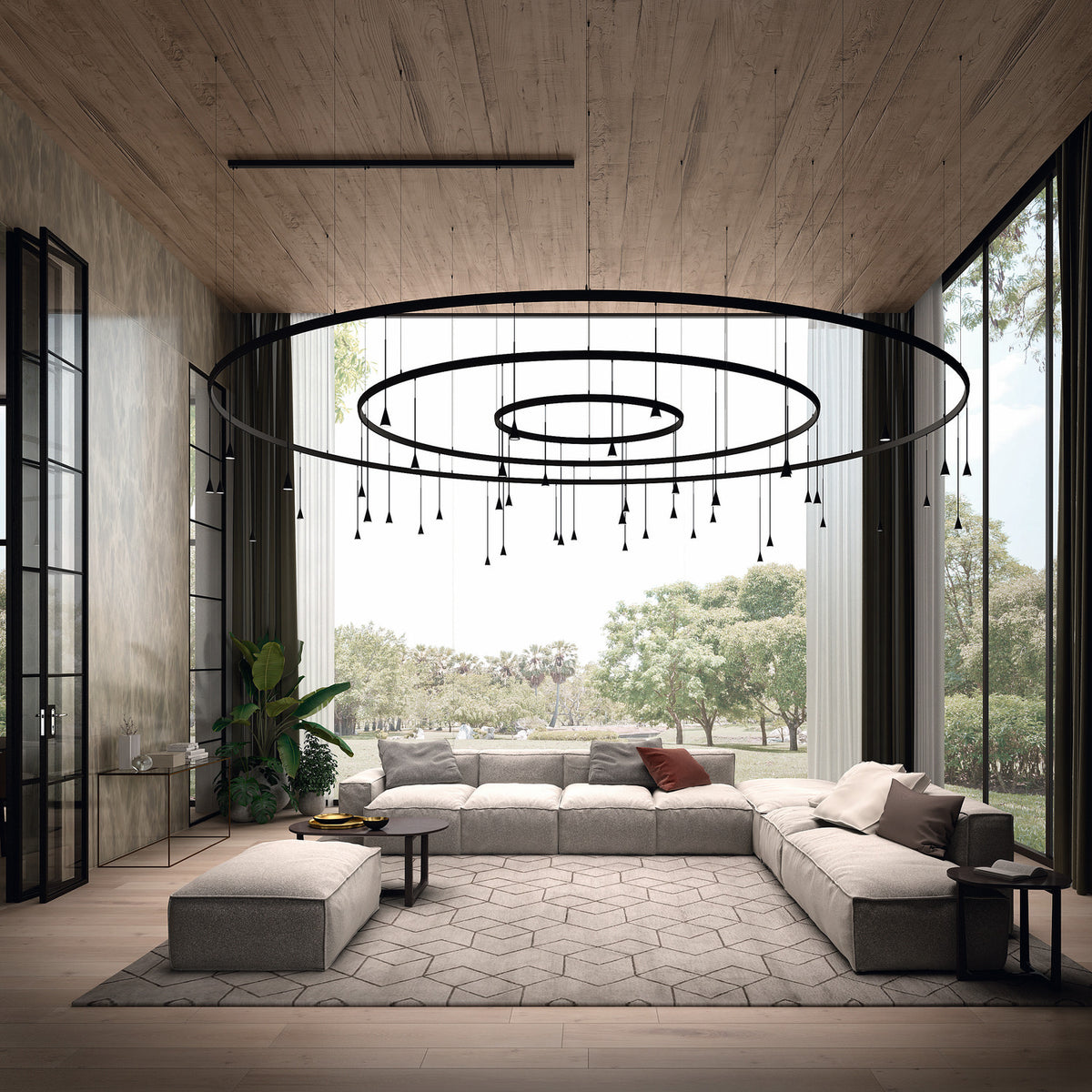 Skybell Circle Iron Ring LED Pendant Light in Ebony Black, with tiered circular rings and small cone heads on slim stems, shown above a sofa in a living room.