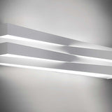 Cross Glass LED Wall Light 30cm in white finish, two crossing bars mounted on a light grey wall with warm white light glowing between them.