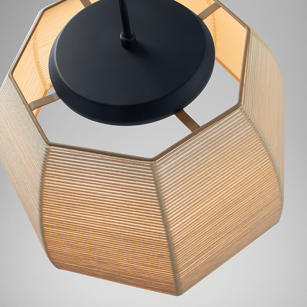 Close-up of the Tanit S/61 LED pendant light showing its octagonal beige cotton-thread shade and matt black canopy with centre stem, against a plain grey background.