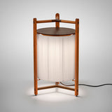 Kando P/76 Ribbon LED floor lamp with cream pleated cylinder shade, teak wood tripod frame, and round brown top, lit against a plain white background.