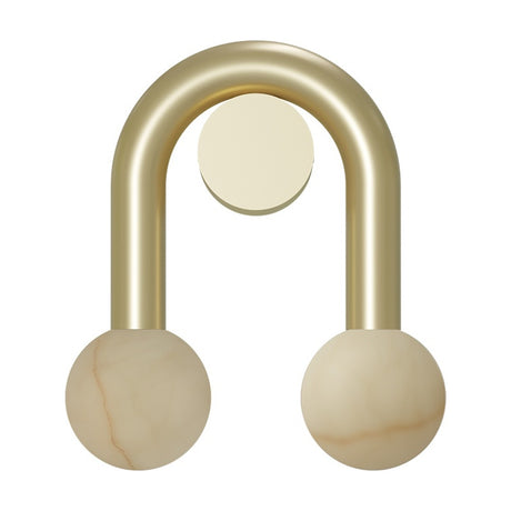 Rigoberta Super Curved Wall Light in gold, an arched iron fixture with a round wall plate and two alabaster globes at the ends, shown on a white background.