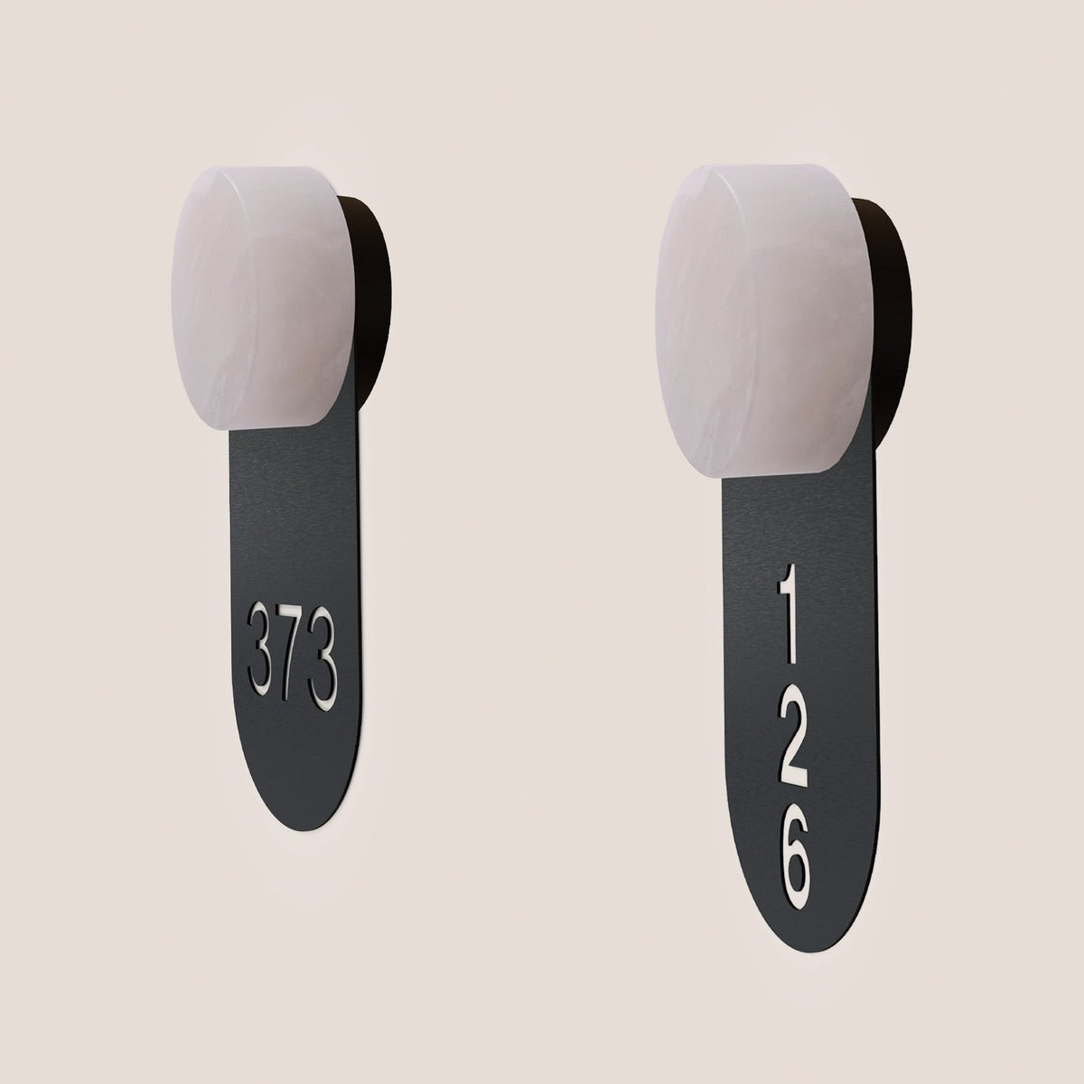 Two Rock wall lights with alabaster round heads and matt black iron signage tags cut with room numbers 373 and 126, shown on a plain light background.