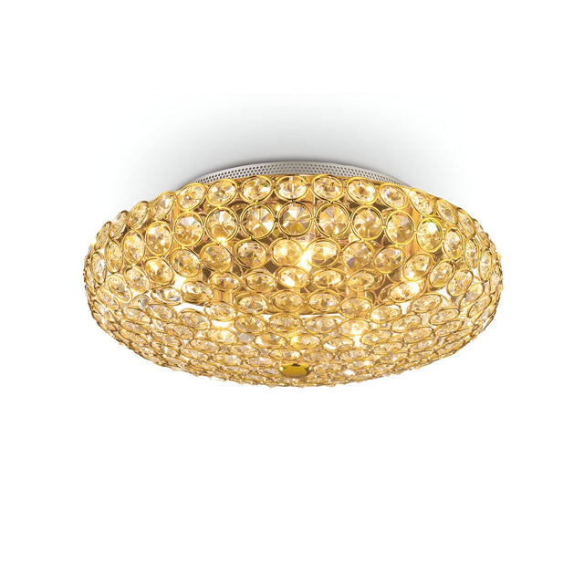 The Queen 5 Light Crystal Ceiling & Wall Light - Gold is an opulent lighting fixture with a ceiling-mounted, round design. It showcases a gold finish enhanced by crystal-like embellishments, casting a warm, ambient glow.