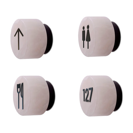 Rock wall lights with matt black iron signage symbols, shown as arrow, male/female, cutlery and room number 127 icons, on a plain white background.