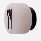 Rock wall light in alabaster with a matt black iron fork-and-knife signage symbol fitted to the front, shown on a plain white background.