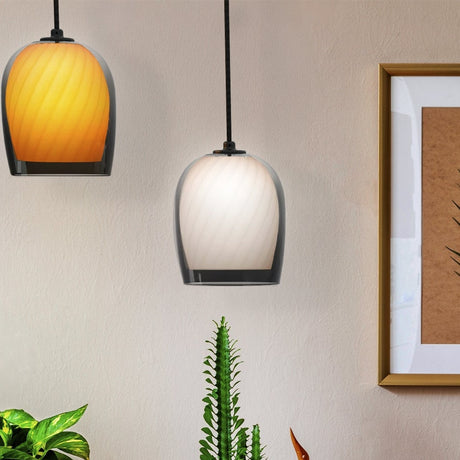 Bruma ribbed glass dome pendant light in gradient smoked and white, shown alongside an orange-toned version in a living room setting with plants and a framed artwork.