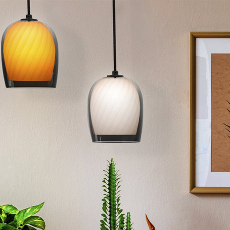 Bruma ribbed glass dome pendant light in oyster white with smoked glass edge, shown beside an amber-toned version against a neutral wall with plants and a framed picture.