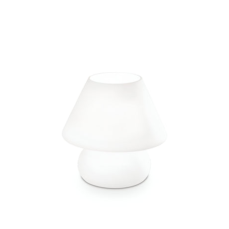 The Prato Small Table Lamp - White boasts a minimalist design with a smooth, rounded base made of white blown glass and a conical shade, creating an ambient glow against its plain white background.