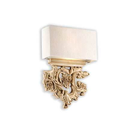 The Vega 2 Light Wall Light - Gold enhances vintage charm with its elegant gold-finished base adorned with a floral pattern and a rectangular white fabric shade, beautifully mounted on a white wall.