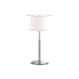 The Satin Large Table Lamp - White features a sleek modern design with a white cylindrical shade and a polished chrome frame. Its glass diffuser softly illuminates any room, and its stylish base stands elegantly against a plain white background.