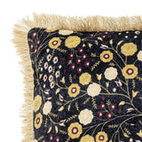 Eydis Floral Cushion in Multi, square fabric cushion with dense floral print in gold, white and burgundy on black, edged with tonal fringe, shown on a white background.
