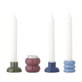 Tana Speckled Candle Holders set in green, pink, blue and light blue stoneware with ribbed and curved stacked shapes, shown with white candles on a plain white background.