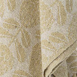 Pratello Throw in yellow, woven fabric with a repeating floral and leaf pattern, shown draped in close-up detail to highlight the textured weave.