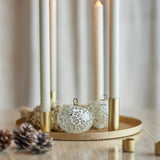 Maxime Iron Christmas Candle Holders set in gold, round textured tray with slim tube holders supporting white taper candles, styled with pinecones and decorative baubles.