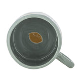 Agnes Stoneware Cup 230ml in green, viewed from above showing the glossy grey interior with a mustard lemon motif on the base and a sage green handle, set against a plain white background.
