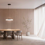 Côte Frosted White Glass LED Pendant Light with a black ceiling canopy, hung low above a wooden dining table in a warm, wood-panelled dining room.