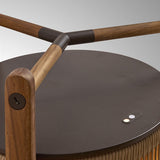 Close-up of the Kando P/111 wood outdoor floor lamp, showing teak crossbars joined by dark brown leather sleeves above a matte brown disc top with integrated LED light control.