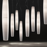 Maxi S/01 Ribbon LED pendant lights in white, tall tapered columns with fine pleated ribbon shades, shown in multiples against a dark background.