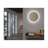 Helios A/02 round LED wall light with oak brown fabric disc and beige thread edge, shown in a hallway and above a sideboard mirror styling.