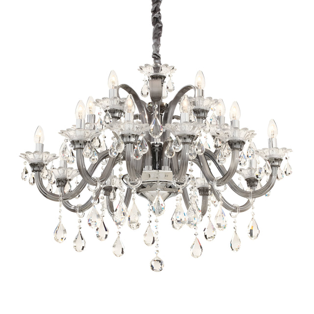 The Vivid Crystal 15 Light Chandelier - Silver features numerous arms decorated with teardrop-shaped crystal pendants. Each arm supports a small light designed to resemble a candle, creating an opulent and illuminated look. This sophisticated piece hangs from a dark braided chain, exuding brilliance and charm throughout the space.