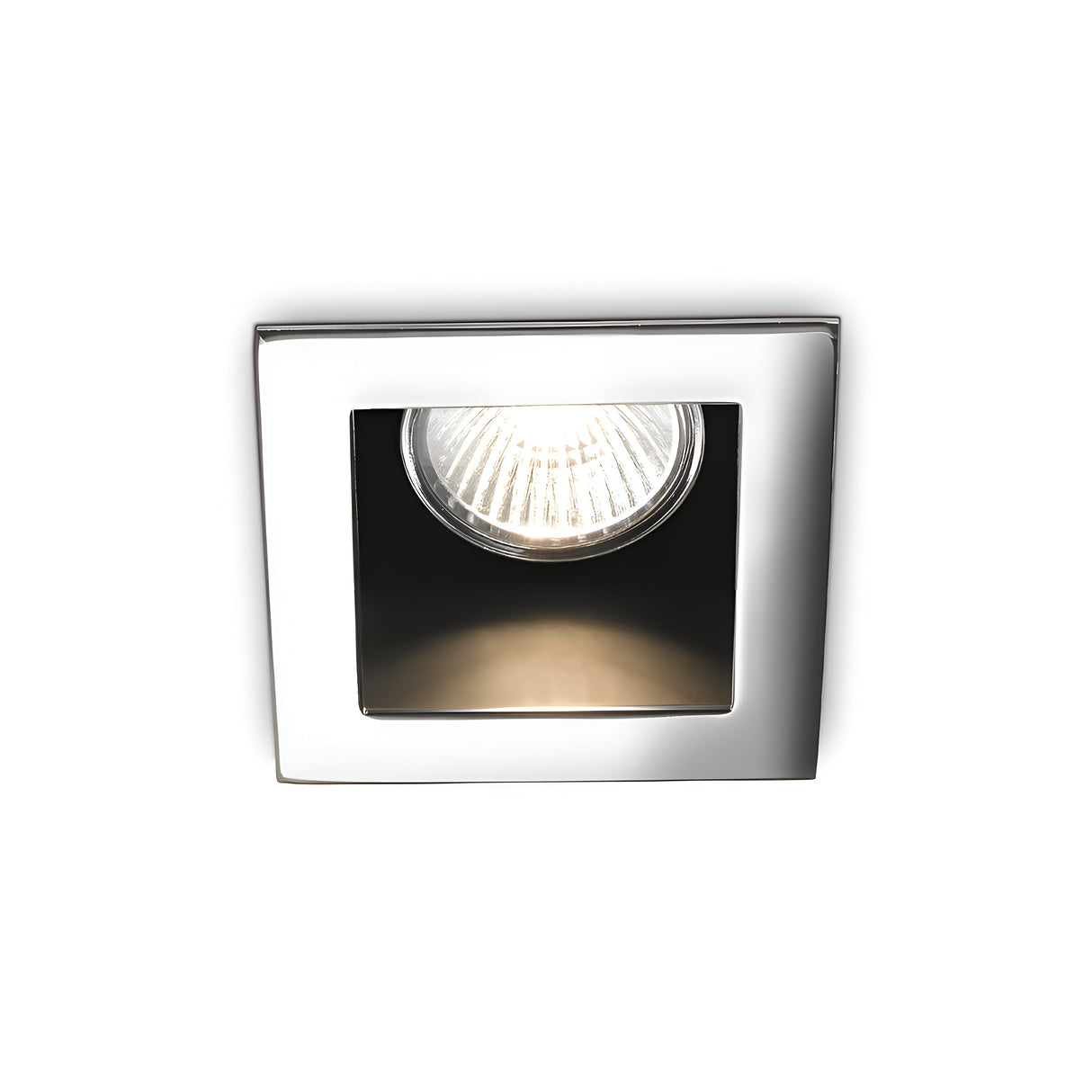 Introducing the Shimmer Recessed Downlight- Chrome, a square, chrome-plated fixture with a contemporary design. It features a single centrally positioned bulb and emits an even glow when illuminated.