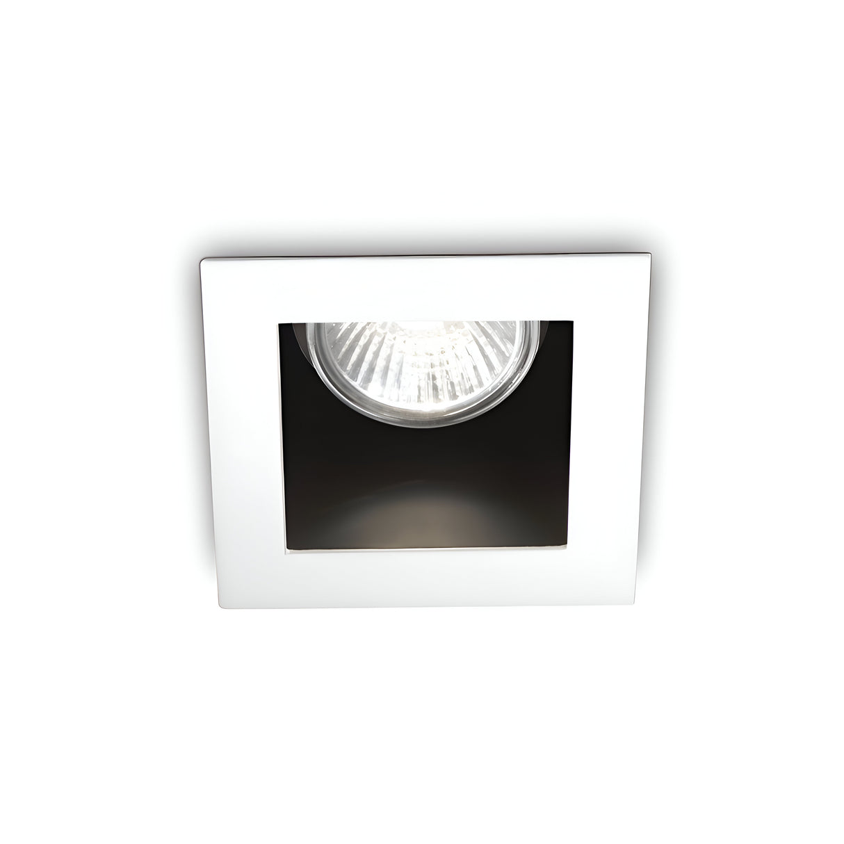 The Shimmer Recessed Downlight - White showcases a square design with a white frame and exposed bulb, providing minimalist illumination with its radiant glow. This durable lighting fixture complements the plain white backdrop, effortlessly merging aesthetic appeal with practicality.