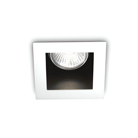 The Shimmer Recessed Downlight - White showcases a square design with a white frame and exposed bulb, providing minimalist illumination with its radiant glow. This durable lighting fixture complements the plain white backdrop, effortlessly merging aesthetic appeal with practicality.