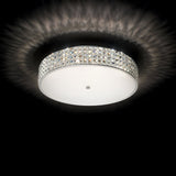The Nebula 9 Light Crystal Ceiling Light - Chrome elegantly enhances modern interiors with its round fixture and decorative crystal-like edge, emitting a soft, radiant glow against a black background. Its design creates a mesmerizing patterned light effect on the ceiling.