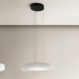 Côte LED pendant light with a shallow frosted white glass disc shade, ribbed underside, and black ceiling canopy on three thin cables, shown against a neutral wall.