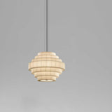 Mos 02 Ribbon Tiered Pendant Light with seven pleated cream translucent ribbon tiers in a tapered round shape, iron structure, shown on a plain grey background.