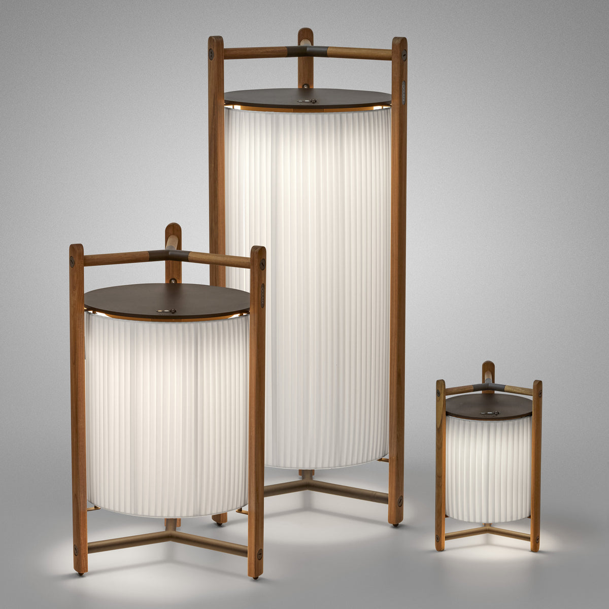 Kando P/111 Ribbon LED Floor Lamp in white, with pleated cylindrical shade in a wood-toned three-legged frame, shown alongside two other sizes on a plain grey background.