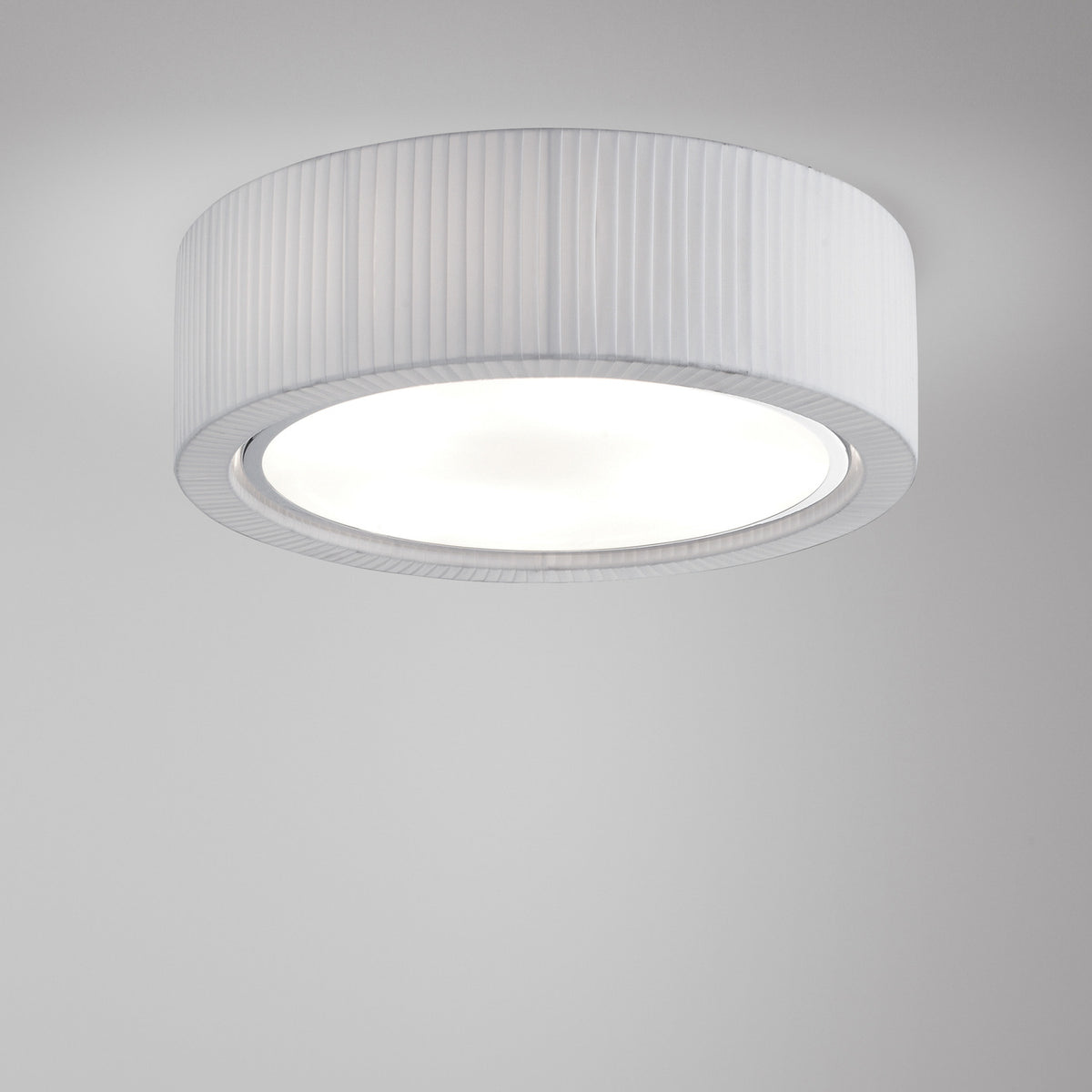 Urban PF/90 Ribbon LED ceiling light with a drum-shaped white pleated shade, round diffuser, and silver trim ring, shown against a plain light background.