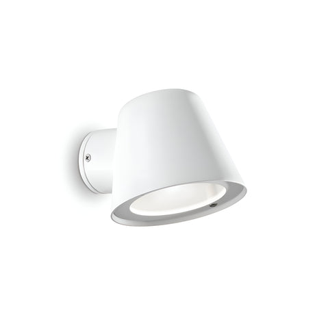 The Quasar Outdoor Wall Light - White boasts a contemporary conical design, skillfully made from powder-coated die-cast aluminium. Its smooth finish and sleek angle make it an elegant addition to any white background, while its IP43 rating ensures reliable durability.