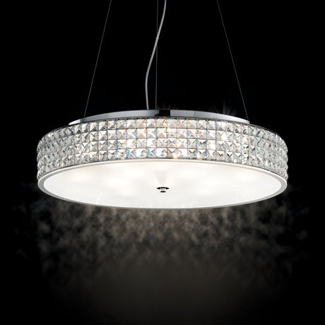 The Nebula 9 Light Crystal Suspension - Chrome is a modern round chandelier featuring crystal accents and a glowing circular light in the center, all suspended by adjustable suspension cables against a dark background.