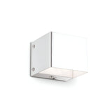 The Vividara Wall Light - White is a sleek, modern fixture with a square design that features clean lines and a minimalist lighting style, perfect for mounting on a plain white wall. Its glossy material is elegantly secured with small screws, exuding contemporary elegance.
