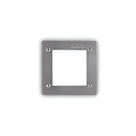 The Polar Recessed Square Outdoor Light - Grey features a recessed square design that enhances its stainless steel construction and white illuminated panel. Ideal for outdoor use, it offers a sleek, modern aesthetic with four corner screws for easy mounting and prominently displays the brand name at the top.