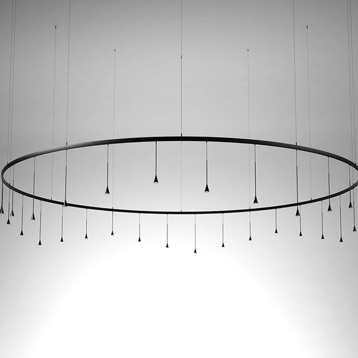 Skybell Circle Iron Ring LED Pendant Light in Ebony Black, a large circular fixture with cone-shaped LED heads on slim stems, suspended on fine wires against a plain grey background.