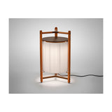 Kando P/76 Ribbon LED floor lamp with a pleated cream translucent cylinder shade, teak wood tripod frame, and round brown top, shown lit on a plain light background.