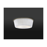Plafonet 43 Ribbon Drum ceiling light with a white translucent pleated ribbon shade and frosted glass diffuser, shown glowing against a dark background.