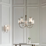 Endon Brenfield 5 light pendant in nickel with curved arms and ribbed glass shades, hanging in a panelled room above a table with a small vase.